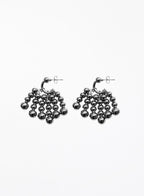 Pair of silver beaded hoop earrings on a white background