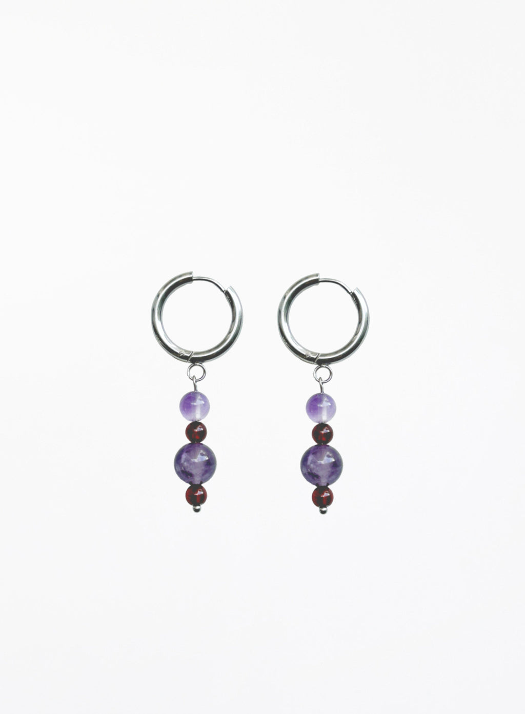 Pair of hoop earrings with purple beads on a white background