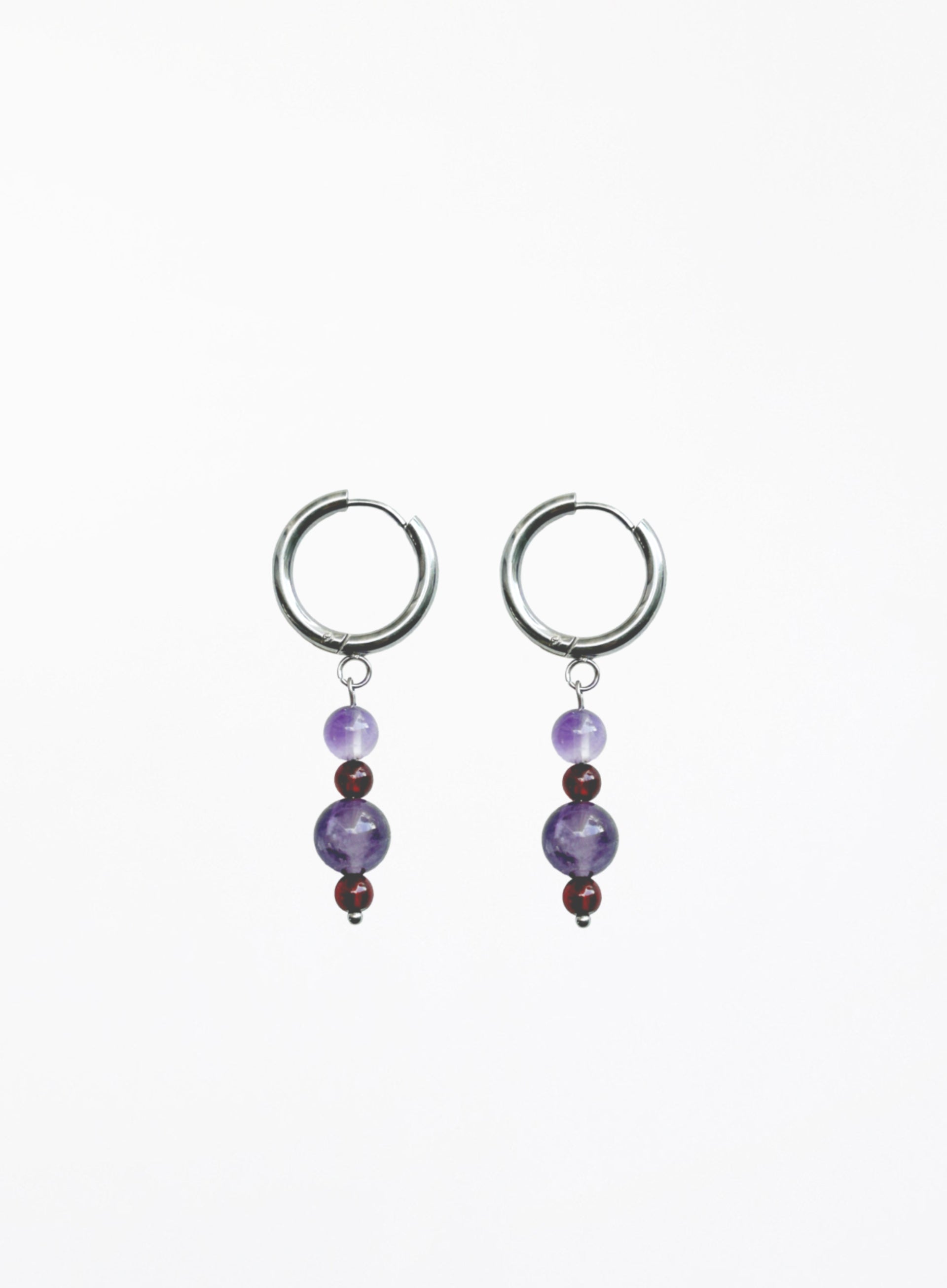 Pair of hoop earrings with purple beads on a white background