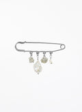 A silver safety pin brooch decorated with four dangling baroque pearl and labradorite beads of varying sizes, set against a plain white background.