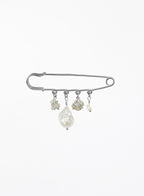 A silver safety pin brooch decorated with four dangling baroque pearl and labradorite beads of varying sizes, set against a plain white background.