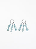 A pair of silver hoop dangle earrings with three strands of light blue chip stones hanging from each hoop, shown against a plain white background.