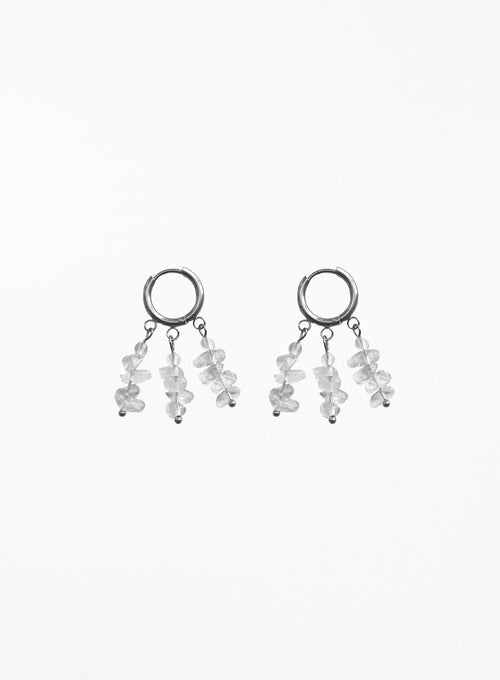 A pair of silver-toned dangle earrings featuring small clear faceted gemstone clusters hanging from open circular hoops, shown against a plain white background.
