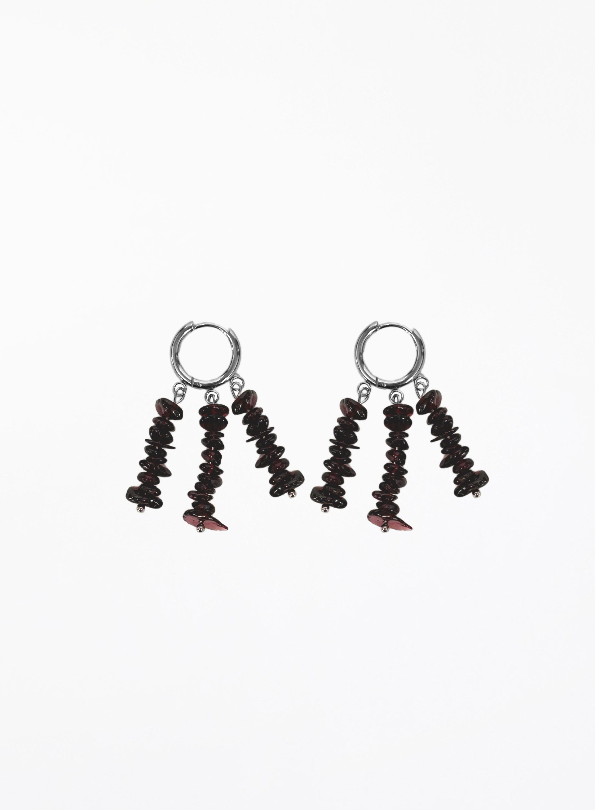 A pair of drop earrings featuring silver-tone hoop tops and dangling clusters of dark brown to black disc-shaped beads with small red accents, shown on a plain white background.