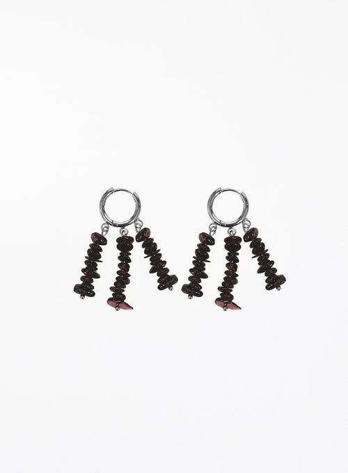 A pair of drop earrings featuring silver-tone hoop tops and dangling clusters of dark brown to black disc-shaped beads with small red accents, shown on a plain white background.