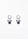A pair of silver hoop earrings with dangling blue beads and dark round stones, shown against a plain white background.