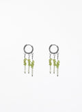 A pair of silver hoop dangle earrings with small green and white beads, shown on a plain white background.