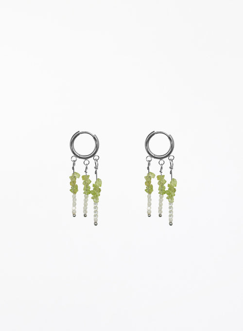 A pair of silver hoop dangle earrings with small green and white beads, shown on a plain white background.