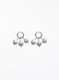 A pair of silver huggie hoop earrings with dangling baroque pearls, shown against a plain white background.