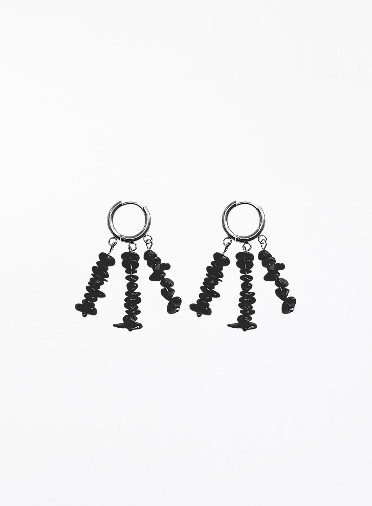 A pair of black dangle earrings with textured, irregularly shaped beads hanging from silver-toned hoop backings, shown against a plain white background.