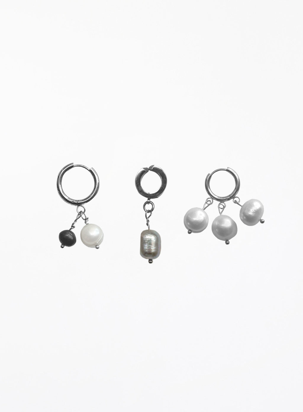 Three pairs of silver hoop earrings with dangling pearl and bead charms, displayed on a clean white background.
