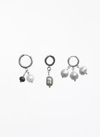 Three pairs of silver hoop earrings with dangling pearl and bead charms, displayed on a clean white background.
