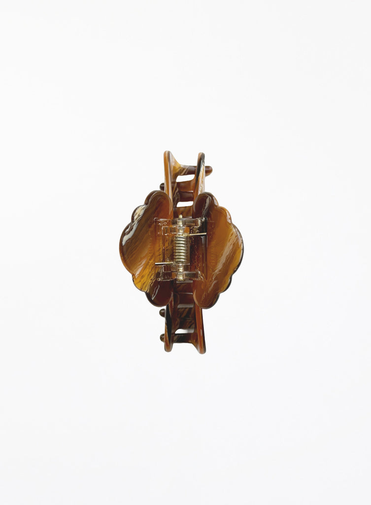 Brown hair clip with marbled pattern on a white background