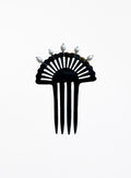 A black resin fan-shaped hair comb with five prongs and five small white decorative pearls on the top, shown against a plain white background.