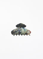 Decorative hair clip with a multicolored design on a white background