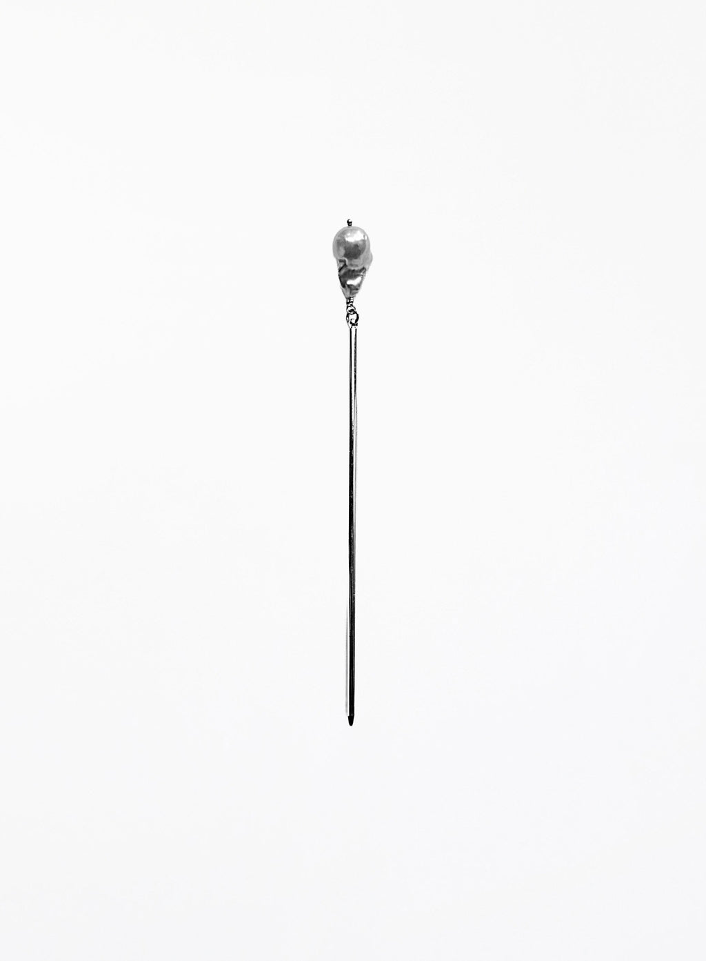 A long, minimalist silver-toned hair pin with natural baroque pearl 