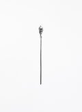 A long, minimalist silver-toned hair pin with natural baroque pearl 