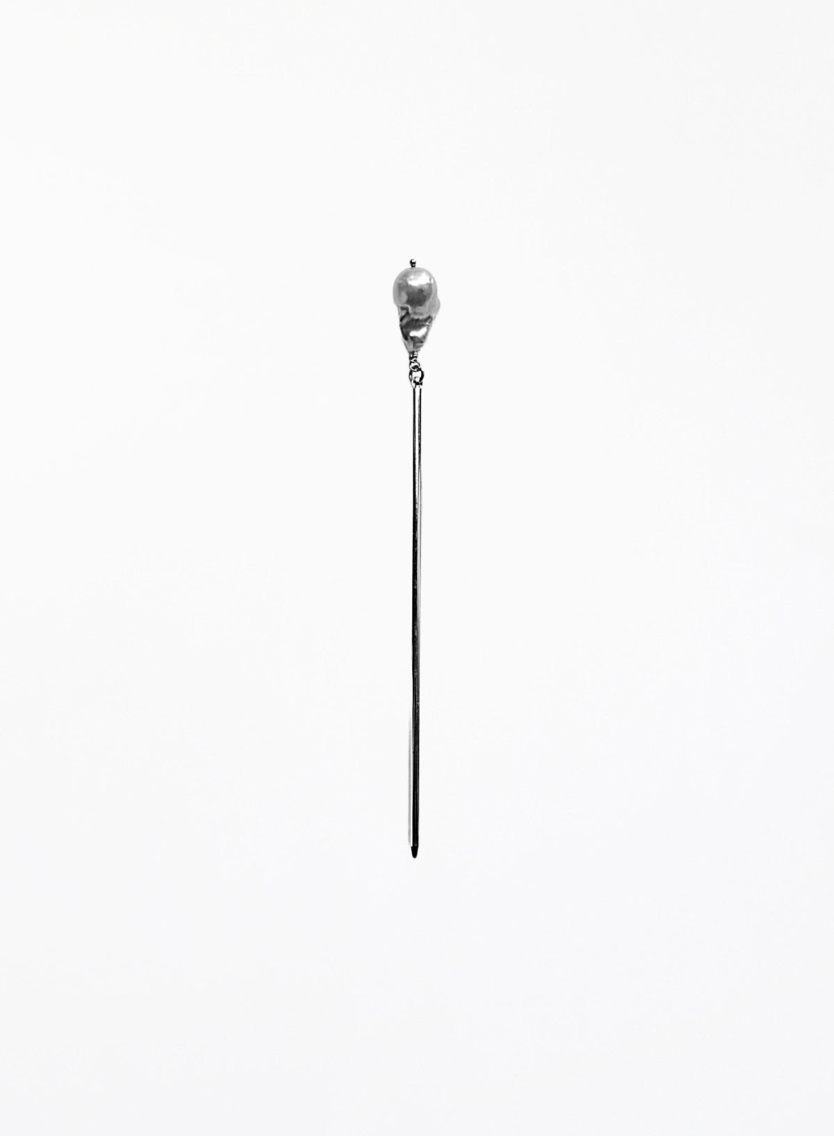 A long, minimalist silver-toned hair pin with natural baroque pearl 