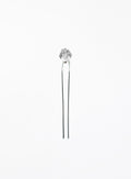 A silver-toned hair pin with a faceted clear crystal top, set against a plain white background.