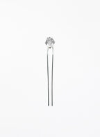 A silver-toned hair pin with a faceted clear crystal top, set against a plain white background.