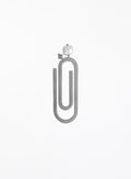 A minimalist steel paperclip-shaped bookmark with a pearl and initial charm shown against a plain white background.