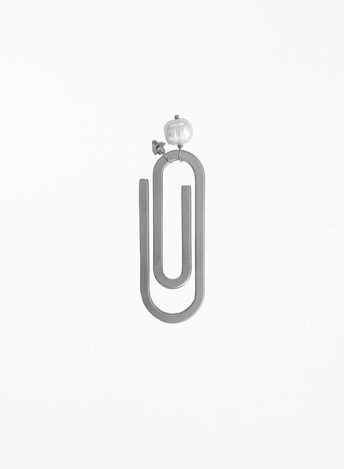 A minimalist steel paperclip-shaped bookmark with a pearl and initial charm shown against a plain white background.