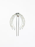 A pearl hair accessory with multiple strands of white freshwater pearls draped over a silver metal hair stick, featuring a central pearl