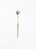 A single long hair pin with a round green and white pearl top and a slender white mother-of-pearl body pin, shown against a plain white background.