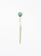 A single long hair pin with a round green and white pearl top and a slender white mother-of-pearl body pin, shown against a plain white background.