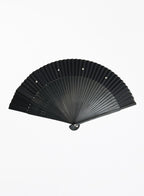A black folding hand fan with a ribbed silk blade and a dark handle, shown open against a plain white background.