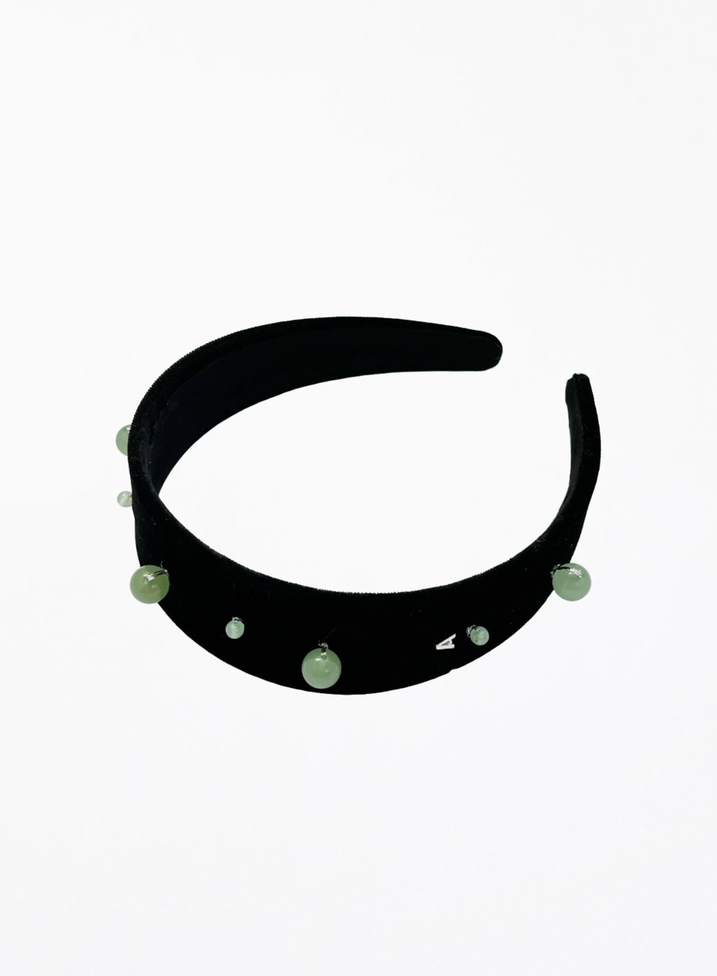 Black headband with green beads on a white background