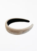 Beige headband with black interior on a white background