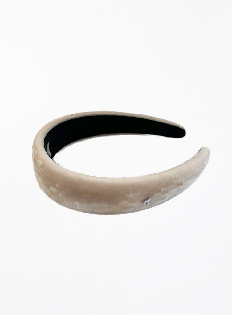Beige headband with black interior on a white background