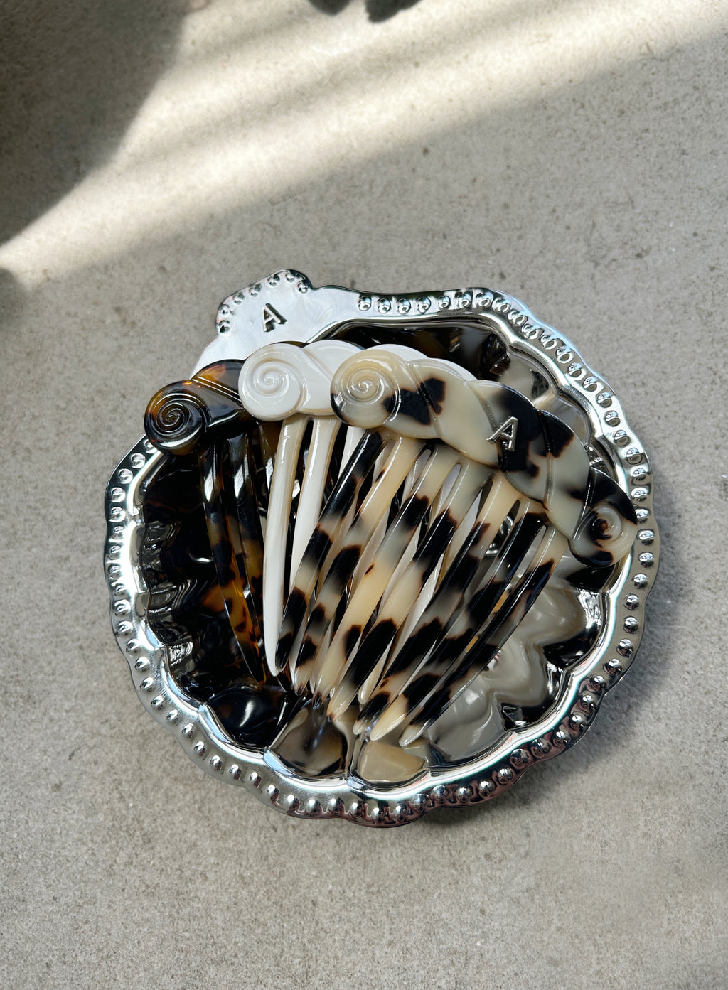 Shell comb with tortoiseshell pattern on a concrete surface