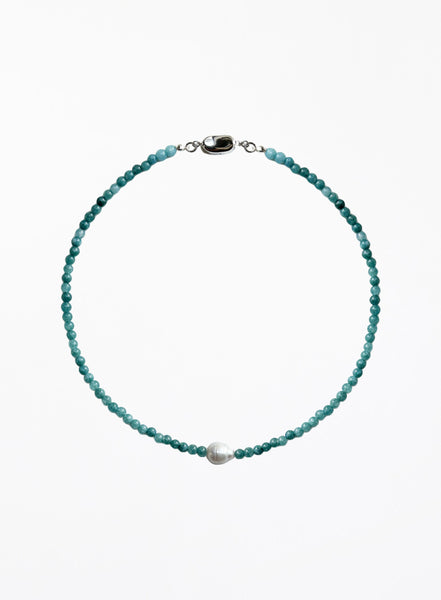 Turquoise beaded necklace with a pearl pendant on a white background