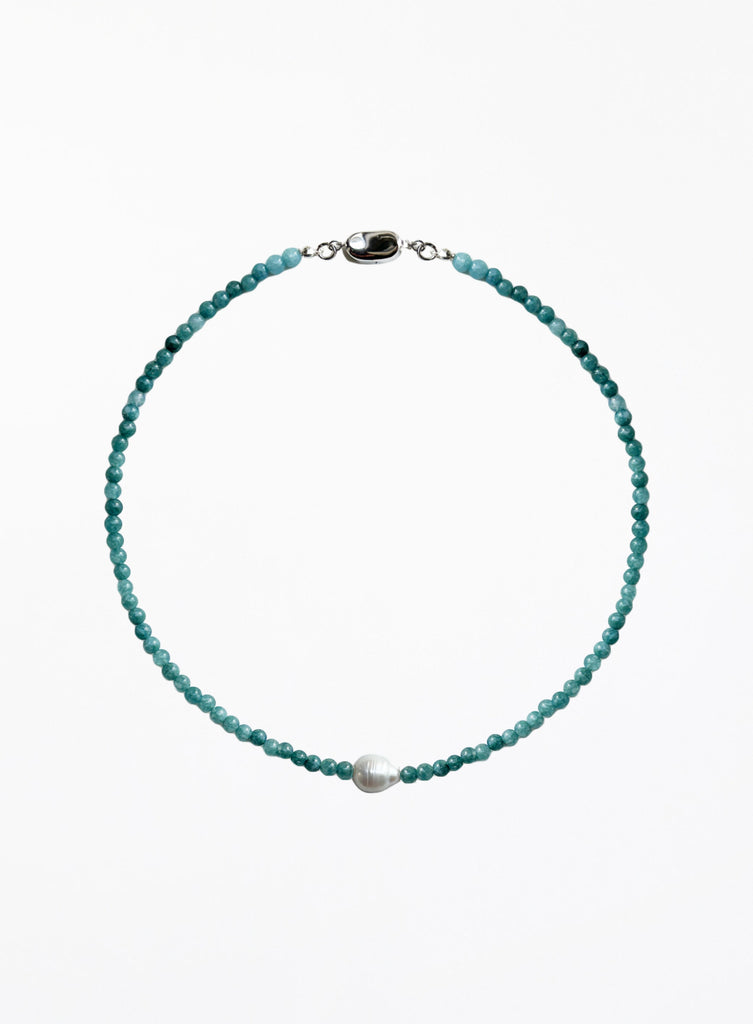 Turquoise beaded necklace with a pearl pendant on a white background