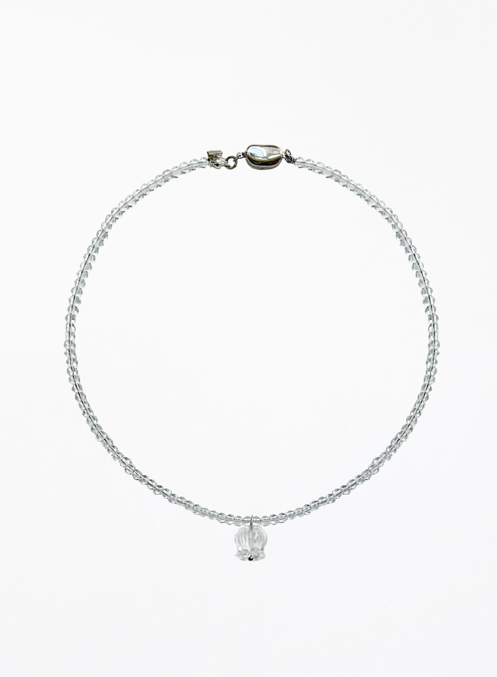 A delicate beaded necklace with a small faceted clear crystal pendant, displayed on a clean white background.
