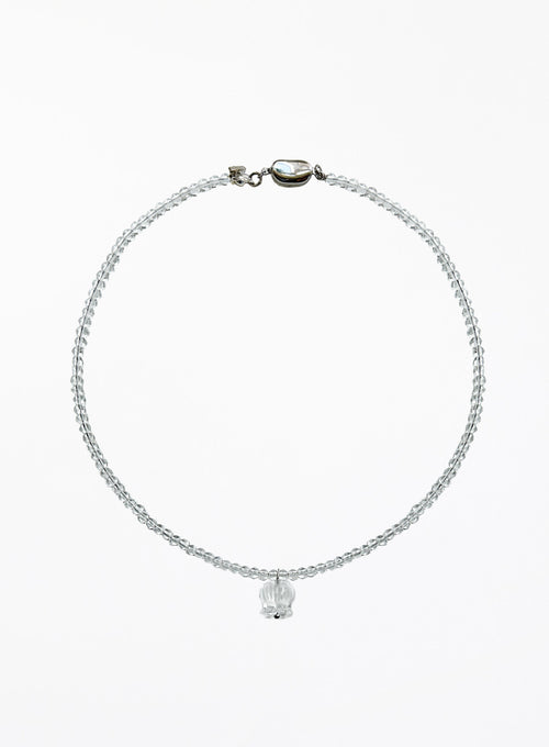 A delicate beaded necklace with a small faceted clear crystal pendant, displayed on a clean white background.