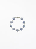 Bracelet with blue beads on a white background