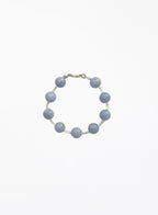 Bracelet with blue beads on a white background