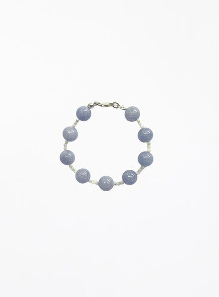 Bracelet with blue beads on a white background