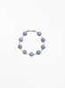 Bracelet with blue beads on a white background