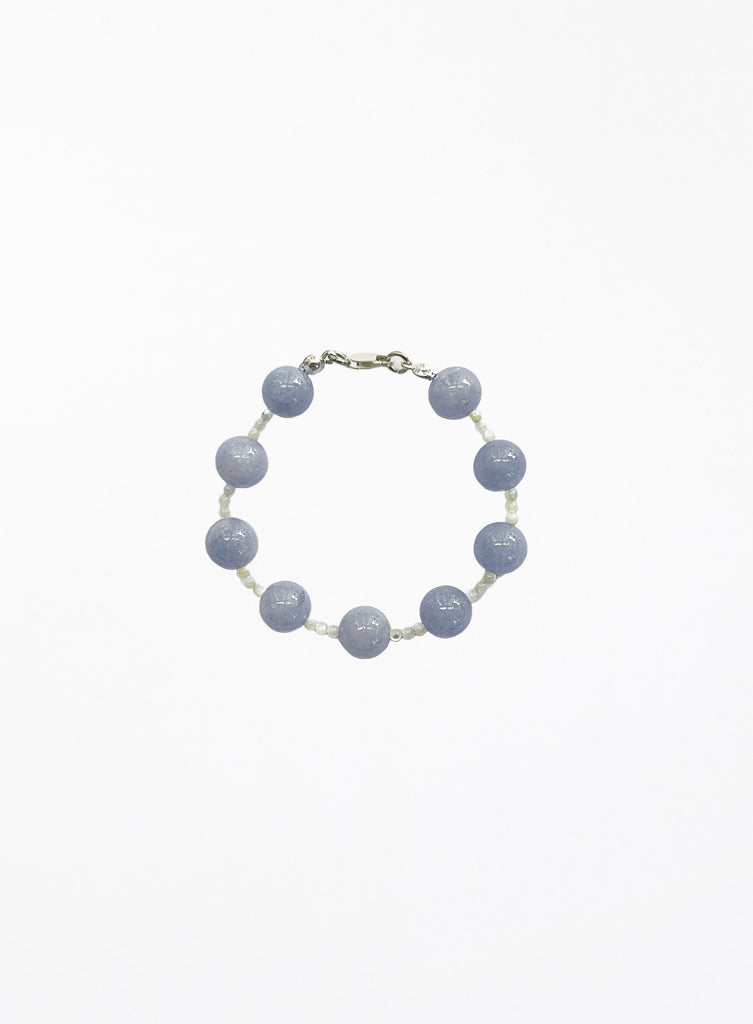 Bracelet with blue beads on a white background