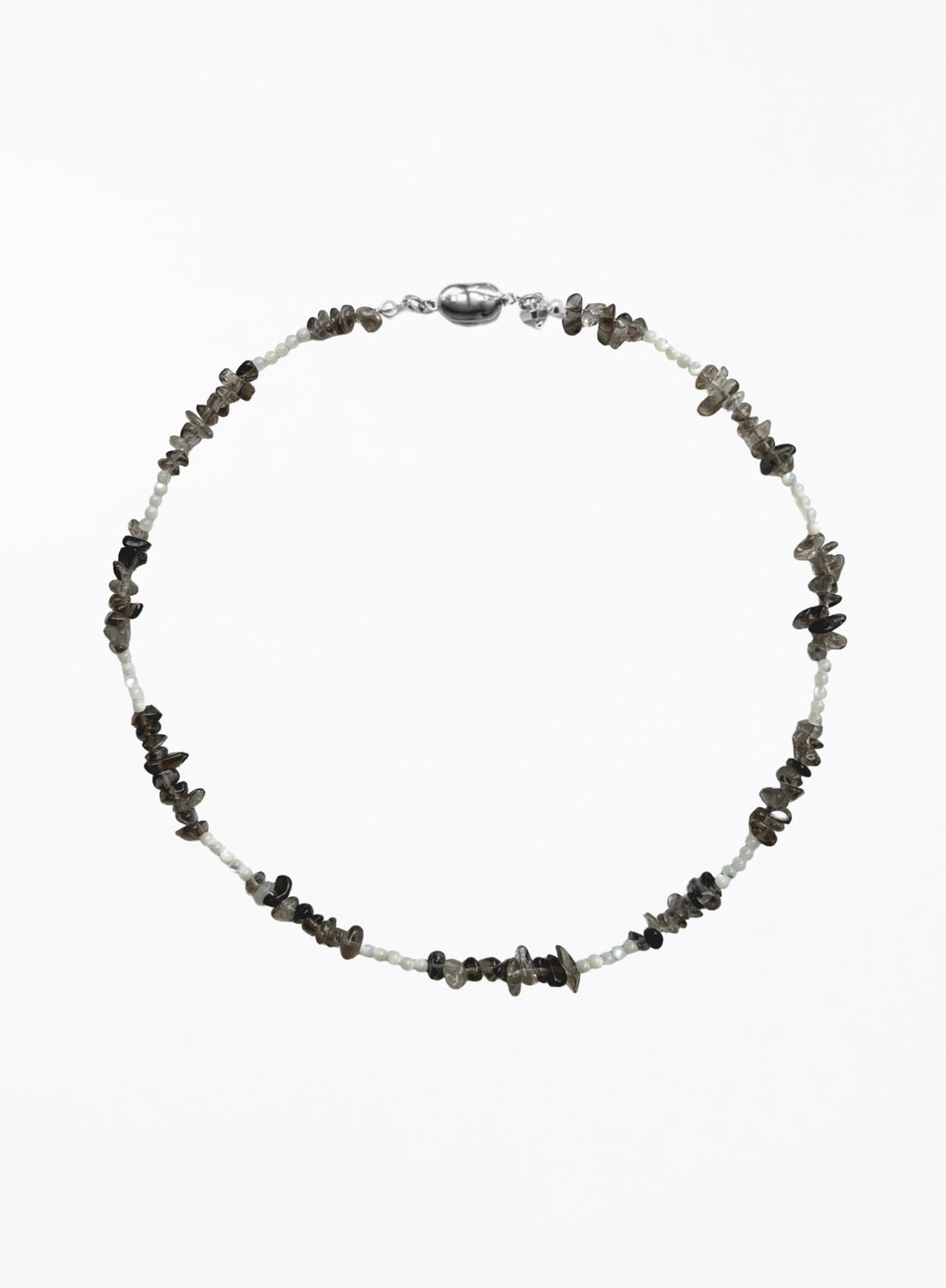 A beaded necklace featuring small white beads alternating with dark gray to black stone chips, finished with a polished silver clasp, shown on a plain white background.
