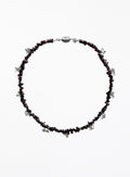 Necklace with red beads and silver accents on a white background