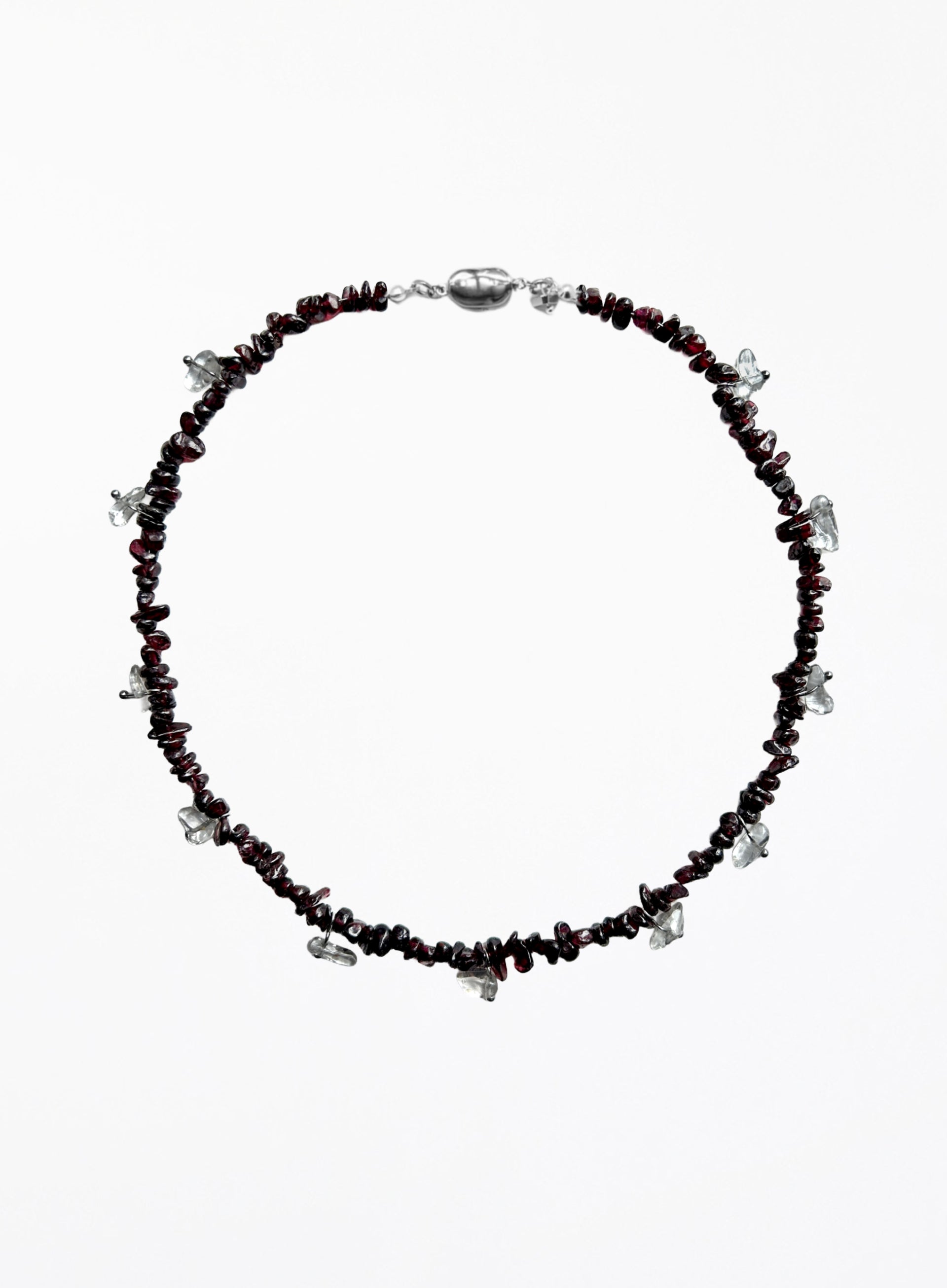 Necklace with red beads and silver accents on a white background