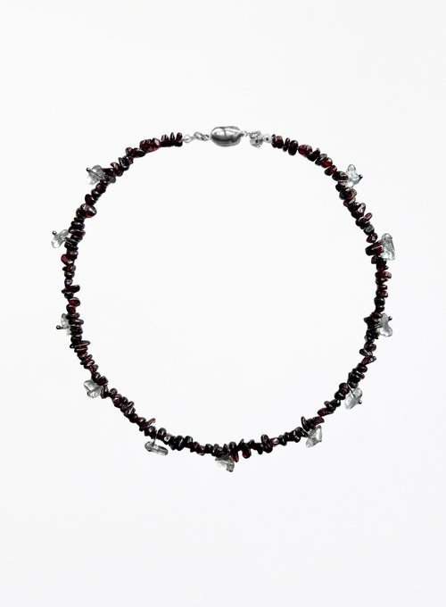 Necklace with red beads and silver accents on a white background