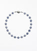 Necklace with blue beads on a white background