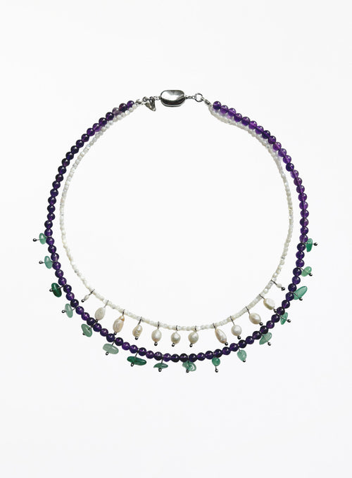 double layered necklace with purple and green beads on a white background