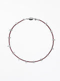 red necklace and small white beads on a white background